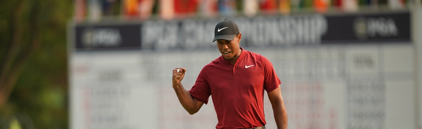 Tiger Woods reacts to making his putt for birdie on the 18th hole during the final round of the 100th PGA Championship