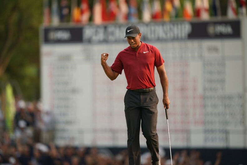 Tiger Woods reacts to making his putt for birdie on the 18th hole during the final round of the 100th PGA Championship