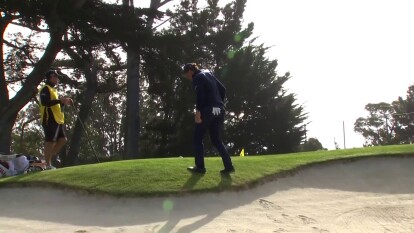 Phil Mickelson hits a tight bunker shot on hole 11