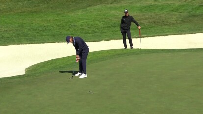 Tommy Fleetwood makes a birdie putt on 1