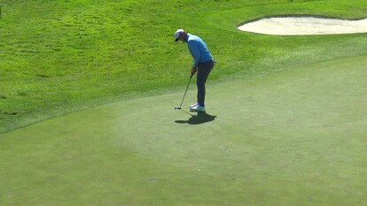 Jon Rahm makes a birdie putt on 17