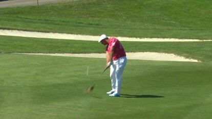 Bryson DeChambeau hits the flag on his approach shot on 18